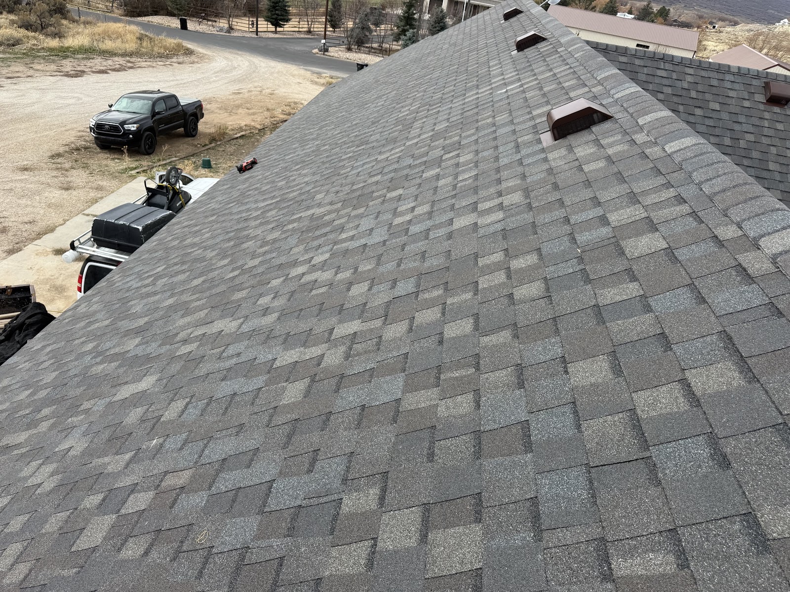 Aerial view of finished residential roof replacement in rural Utah